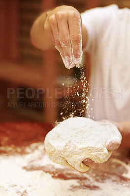 Buy stock photo Closeup of unknown baker sprinkling flour on ball of dough in bakery. Zoomed in on professional woman using hands to make and prepare bread. Pastry chef using white powder before baking loaf of bread