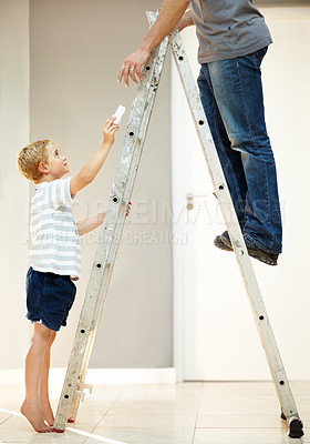 Buy stock photo Young boy helping his father with changing a lightbulb
