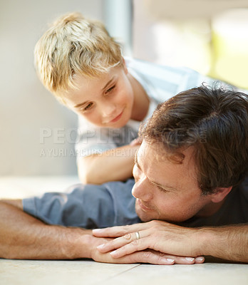 Buy stock photo Smile, relax and dad with son on floor, cute bonding together with care and love in home. Fun, father and child lying on ground in house with happy relationship, trust and support with man and boy.