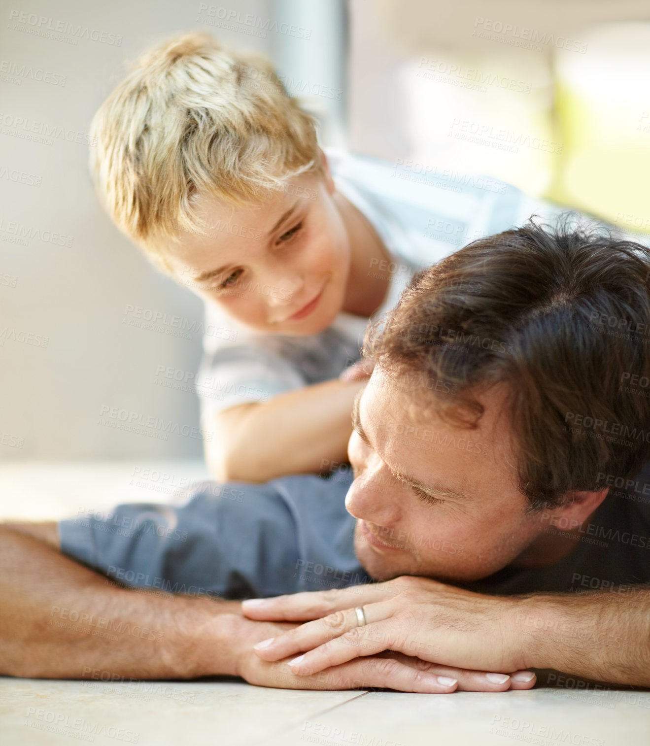 Buy stock photo Smile, relax and dad with son on floor, cute bonding together with care and love in home. Fun, father and child lying on ground in house with happy relationship, trust and support with man and boy.