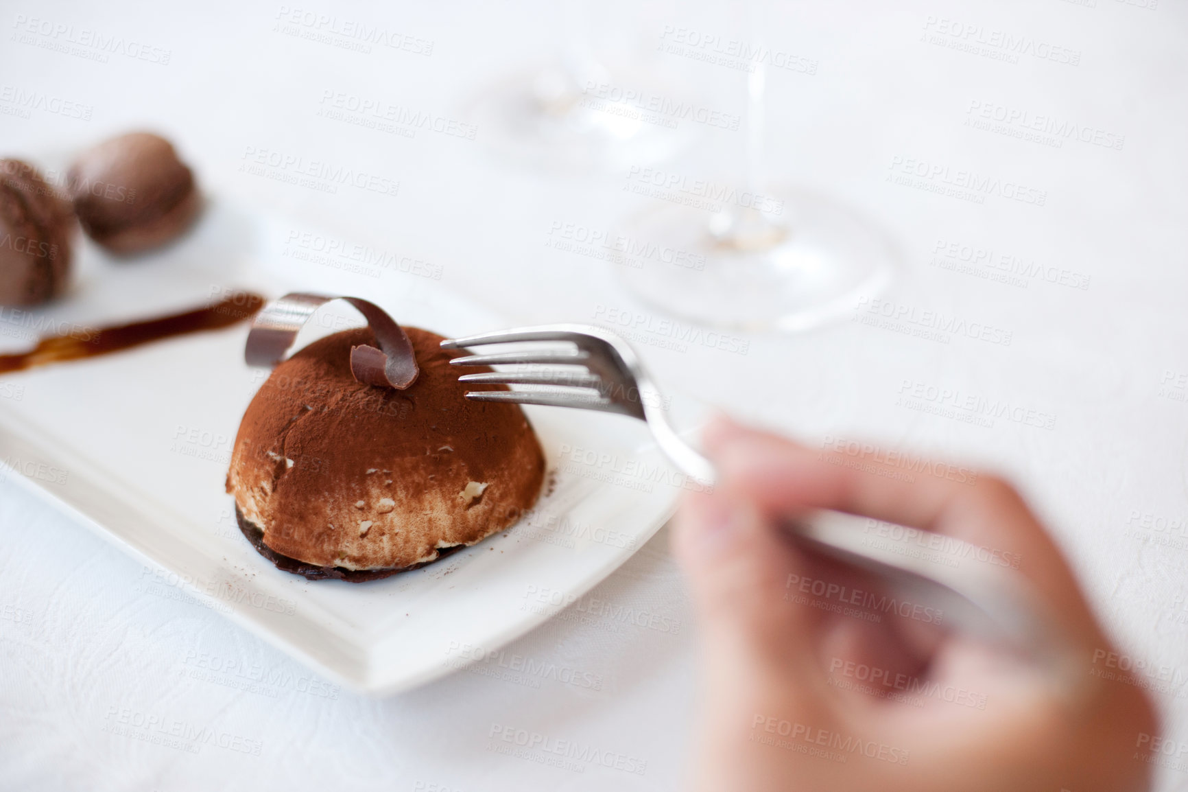 Buy stock photo Hand, fork and eating chocolate dessert at restaurant, fine dining and food at cafe table. Closeup, mousse cake on plate and person hungry for luxury breakfast meal, cacao sugar or sweets in bakery
