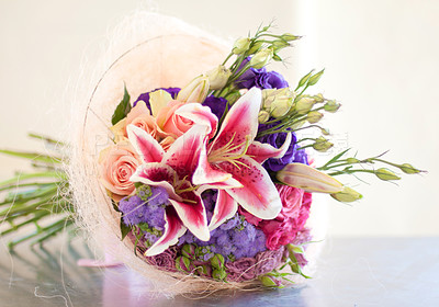 Buy stock photo Closeup of a fresh bouquet of flowers and roses with colorful Balladonna lilies on a table with copyspace. A beautiful bunch of roses on a counter as a celebration, romantic gesture, apology or gift 