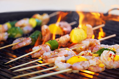 Buy stock photo Closeup of a prawn skewers cooking a the grill