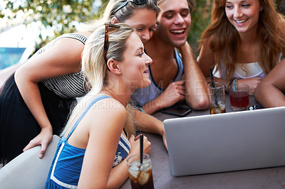 Buy stock photo Happy, weekend and friends with laptop at a restaurant for a meme, social media or funny video. Laughing, group and men and women with a computer at an outdoor cafe for conversation or comedy online