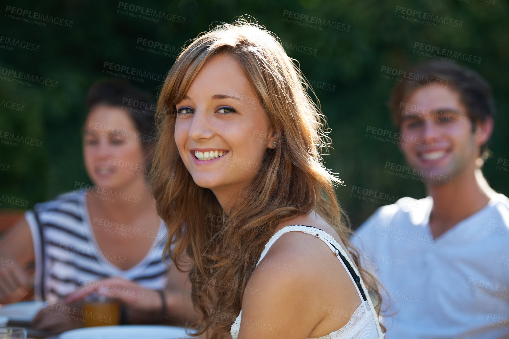 Buy stock photo Happy, woman and portrait in backyard with friends at a table with young people and smile. Lunch, home garden and group ready for eating on a summer break together and relax outdoor of a house