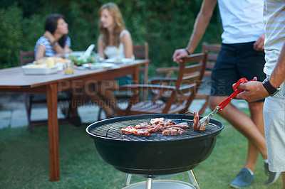 Buy stock photo Young guys barbecuing meat on the grill outdoors - Lifestyle