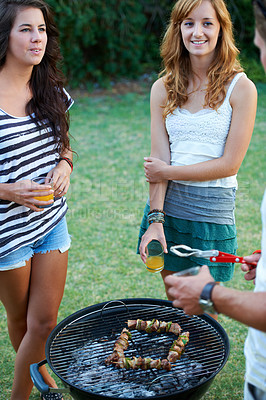 Buy stock photo Happy, friends and grill in backyard of home with juice, food and teen conversation in garden. BBQ, young people with talking group with smile outdoor with discussion and meat ready for summer