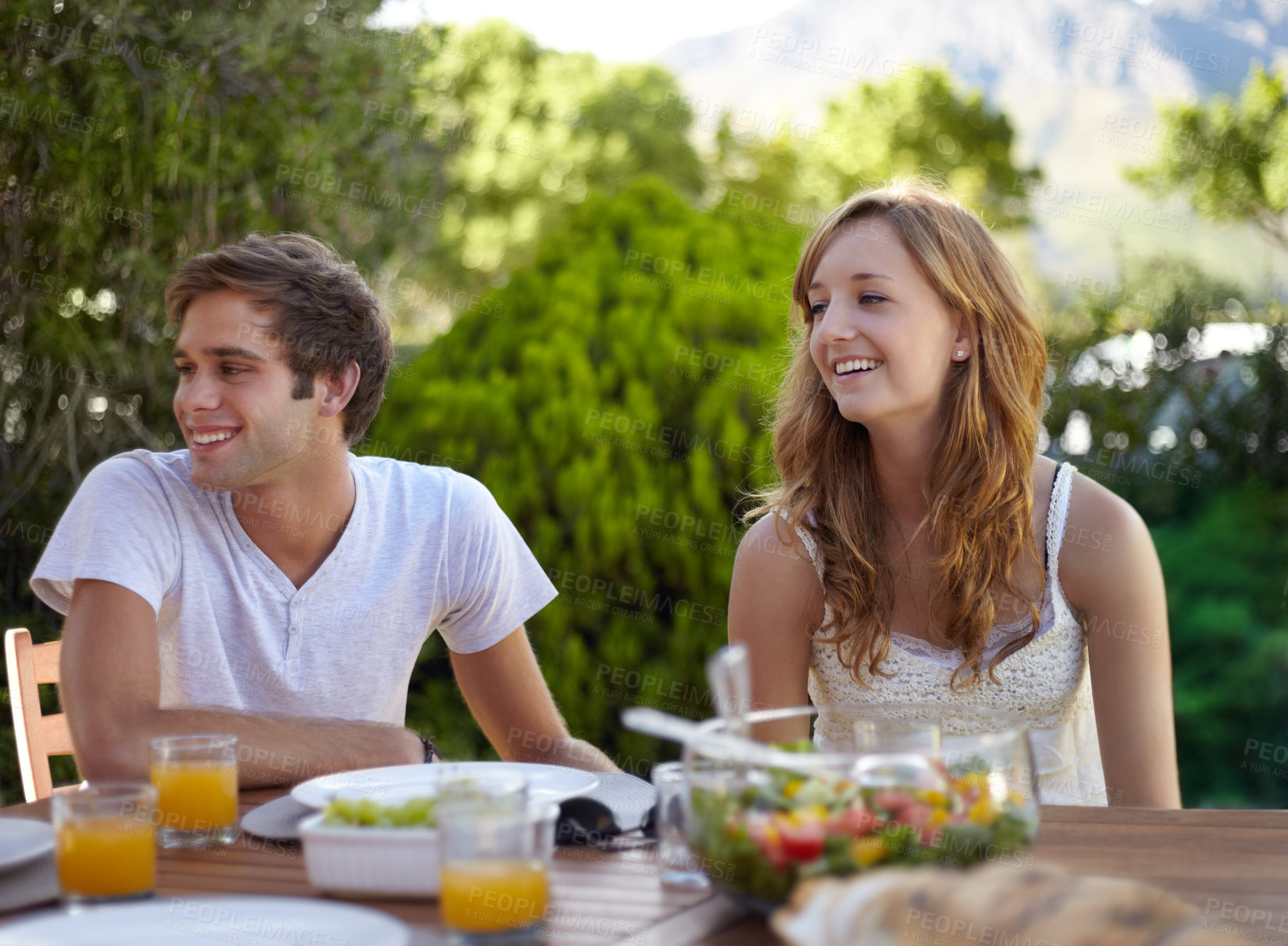 Buy stock photo Happy, friends and food for lunch in backyard with friends at a table with young people and smile. Discussion, home garden and group ready for eating on a summer break and relax outdoor of a house
