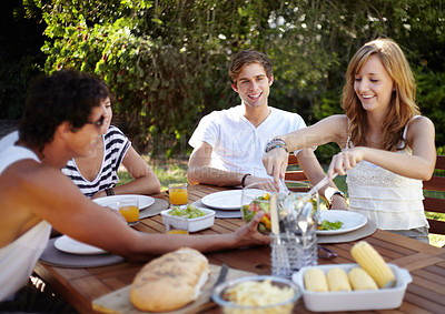 Buy stock photo Smiling young people at a lunch with a group of friends - portrait
