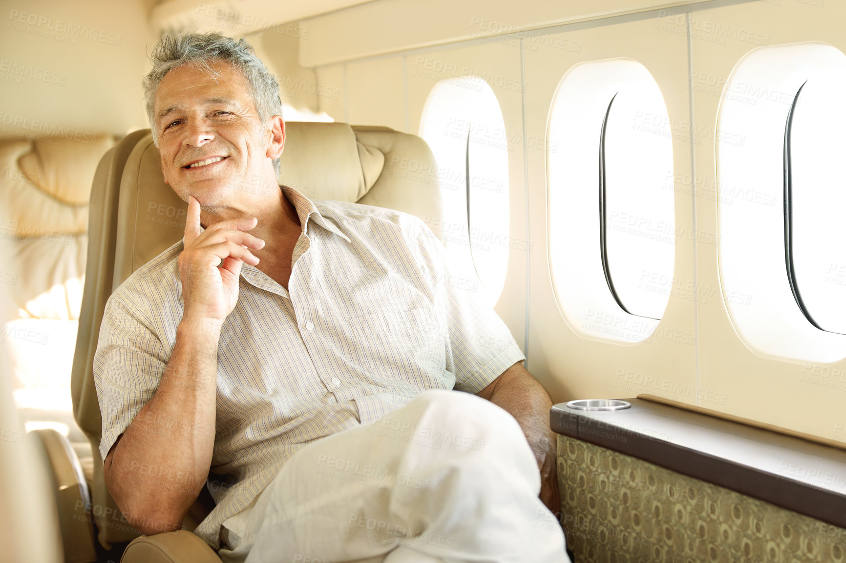 Buy stock photo Portrait of a handsome senior man sitting in an airplane with a smile