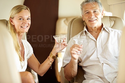 Buy stock photo Portrait, happy couple and champagne in private jet on holiday, vacation and travel. Mature man, woman and alcohol glass on flight, toast and cheers in airplane transport, journey and smile together