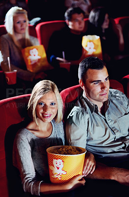 Buy stock photo Cinema, portrait and couple with popcorn, movie and eating on romantic date night together. Watching film, man and woman in theater with snacks, eyewear and sitting in auditorium to relax at premier