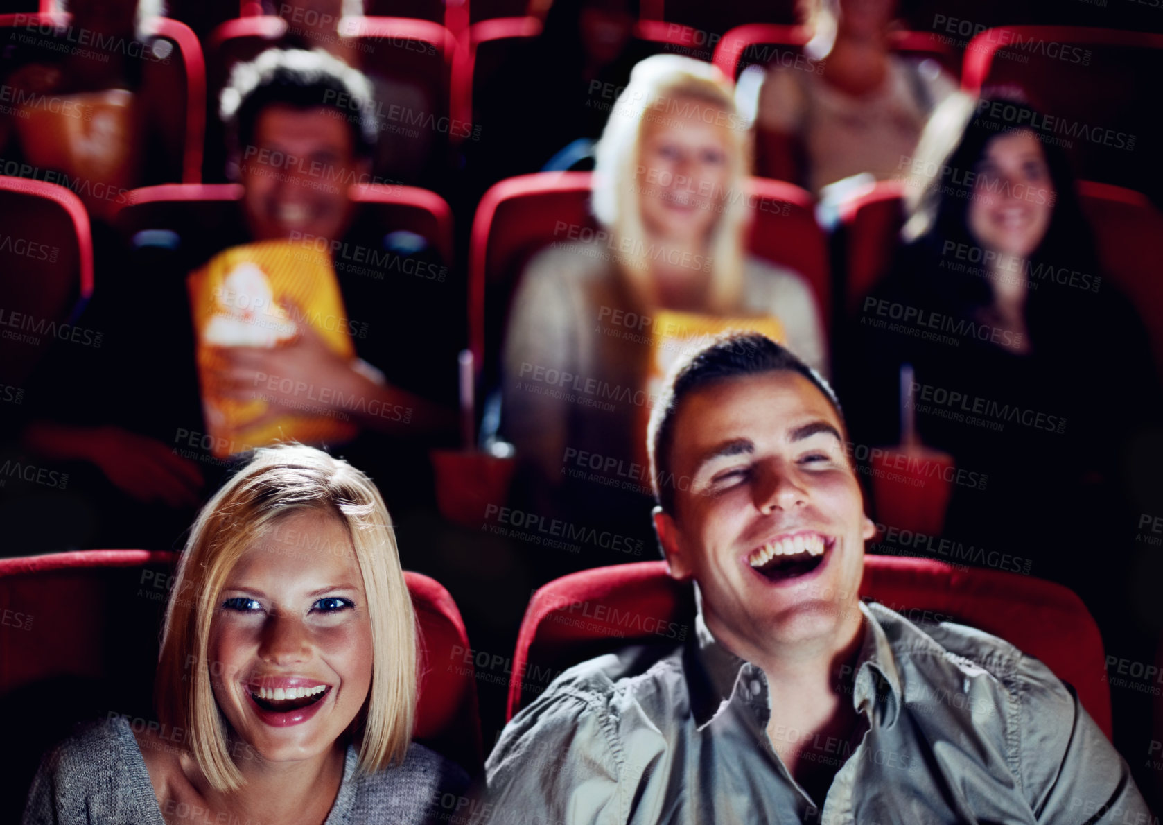 Buy stock photo Couple at cinema movie theatre for funny, comic and happy film show in audience auditorium on a date. Smile, relax and laughing people watching comedy movies on big screen in a dark theater together