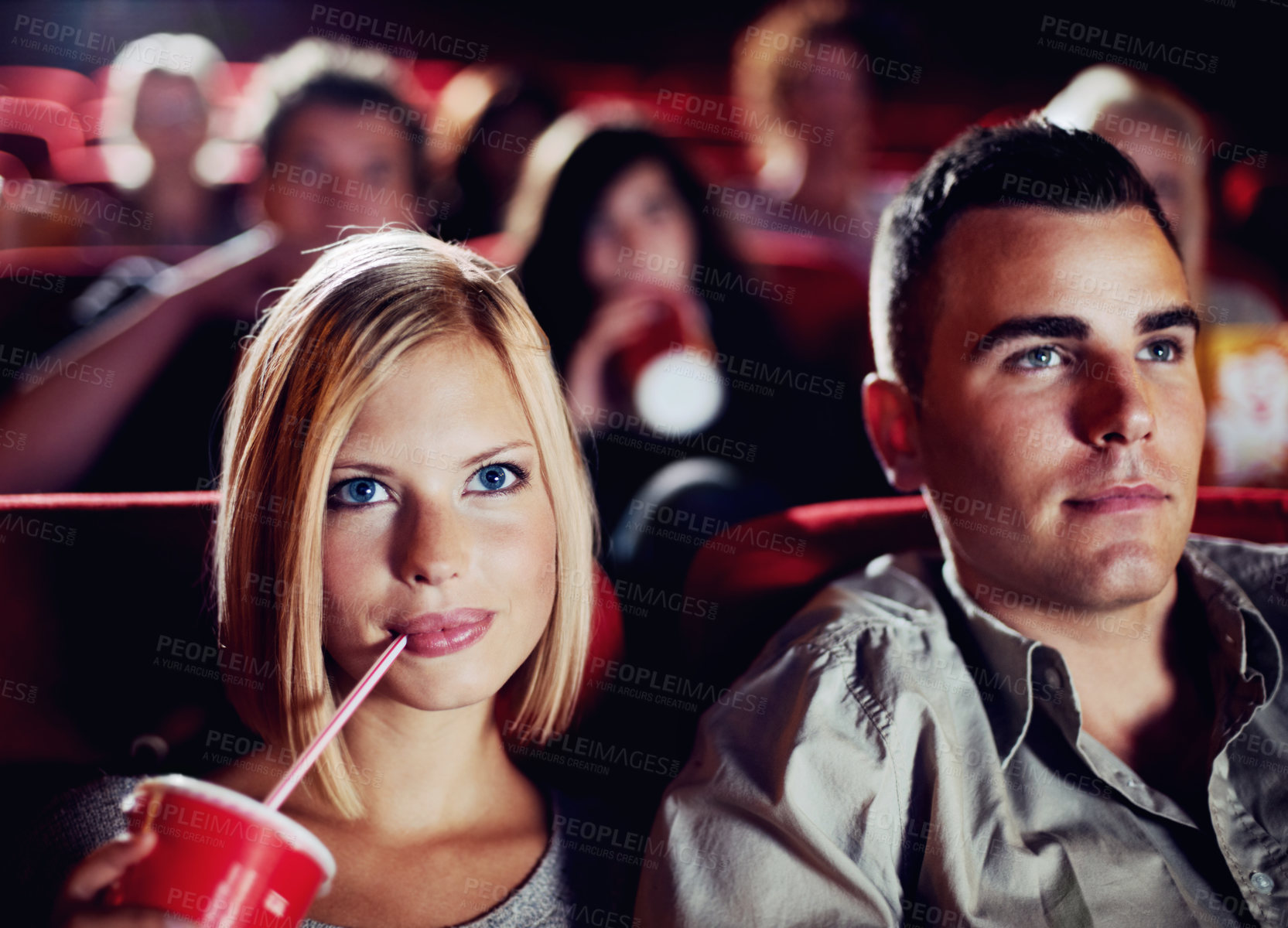 Buy stock photo Couple in dark movie theatre, drinking cola on date in cinema and man and woman watching a film together for entertainment. Face of happy, dating and fun boyfriend and girlfriend at the movies