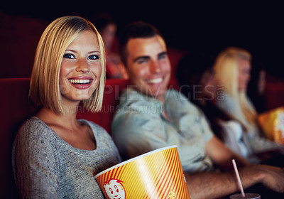 Buy stock photo Movie, popcorn and smile with woman on a date with man at cinema interior or theater event. Happy, film or show screen with couple eating snacks and watching together at night time