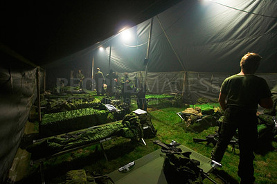 Buy stock photo Soldiers getting ready to bunk down inside of their large tent