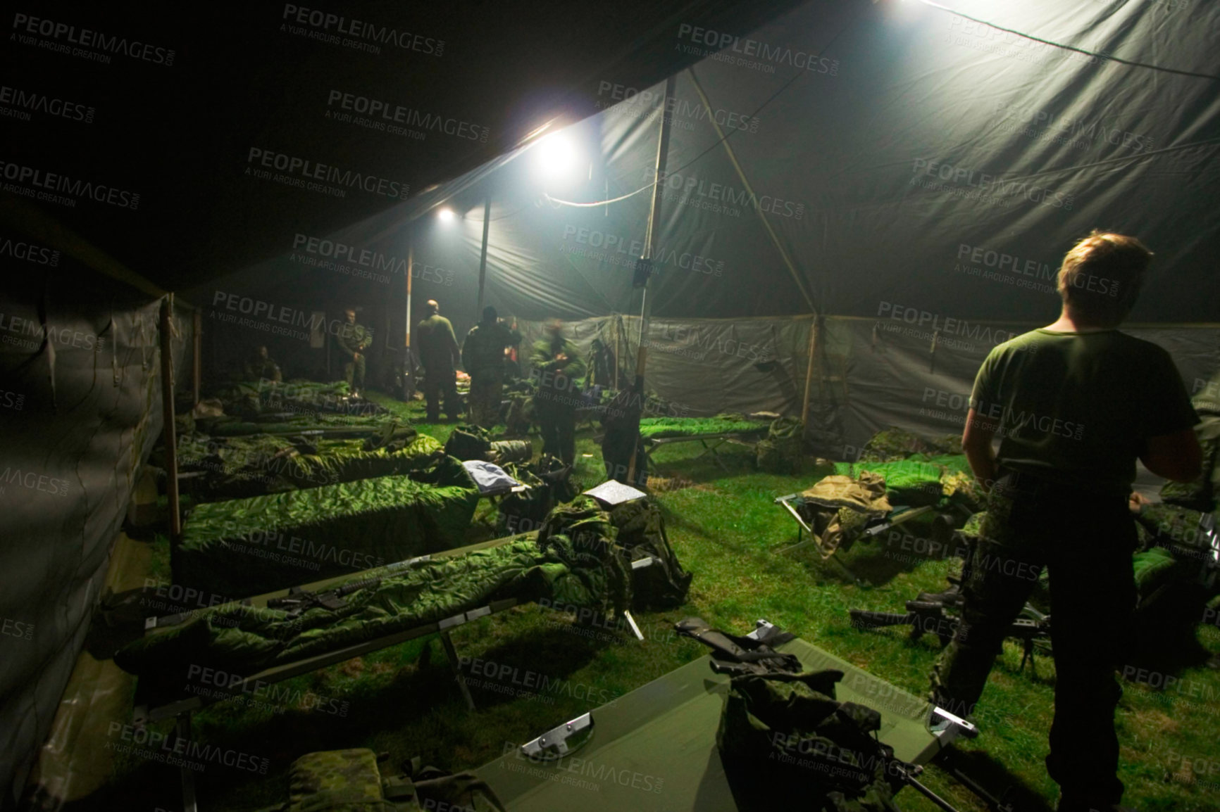 Buy stock photo Soldiers getting ready to bunk down inside of their large tent