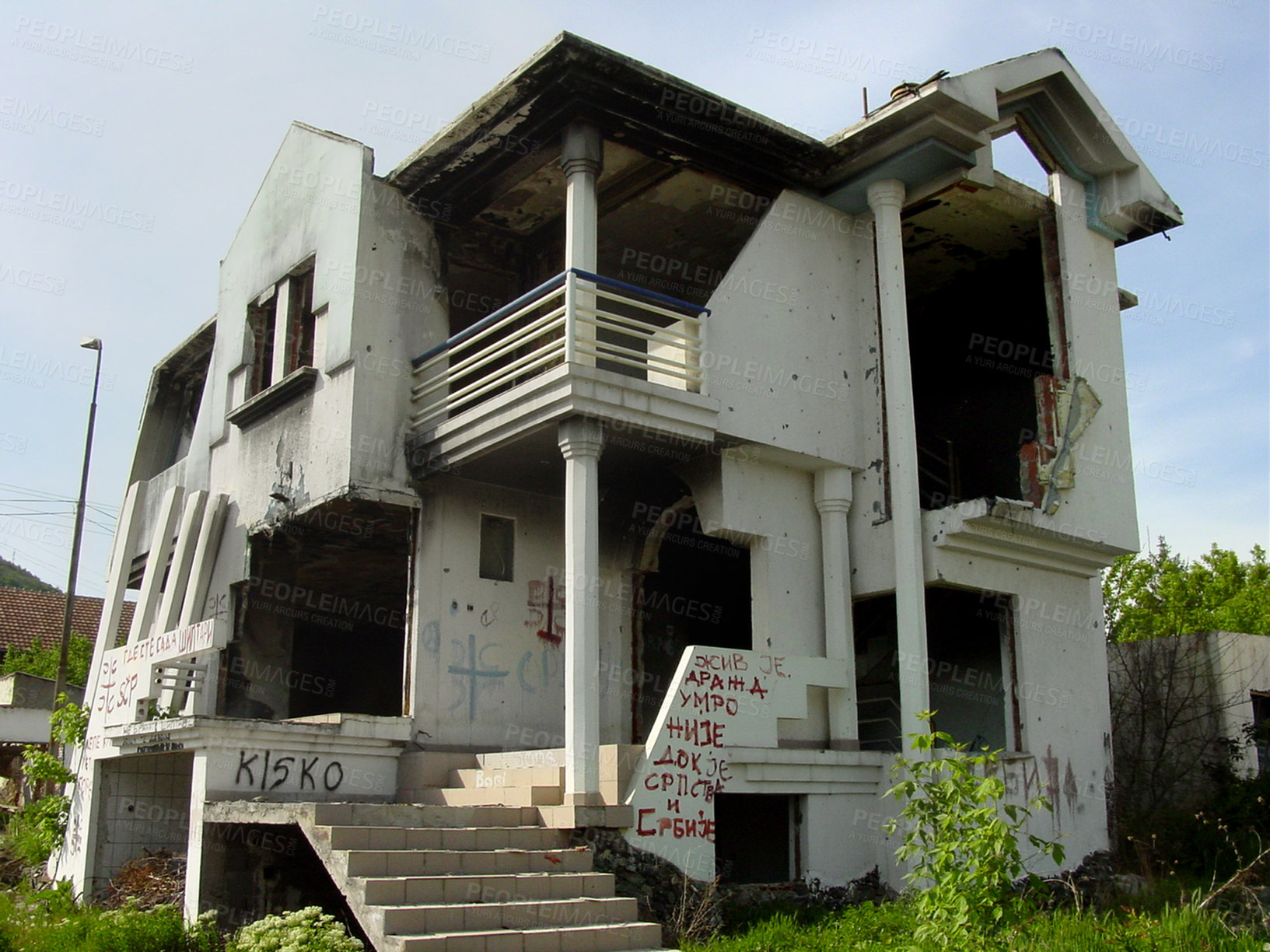 Buy stock photo Abandoned, house and outdoor with war, ruins and destruction of countryside property from bomb disaster. Warzone, land or rubble of grunge apartment, building or old home with graffiti on wall