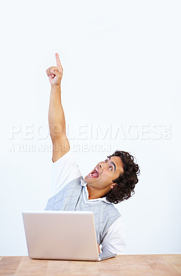 Buy stock photo Celebrate, laptop and businessman pointing up winning, celebrating and isolated in a white studio background. Office desk, winner and male employee or worker showing mockup due to achievement
