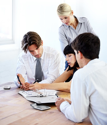 Buy stock photo Collaboration, writing and file with a business team in the boardroom, working together on a project. Teamwork, planning or strategy with men and women employees at work in the office on a project