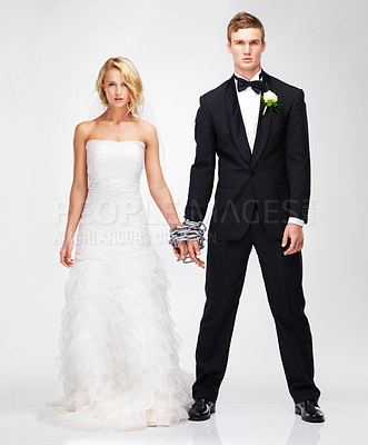 Buy stock photo Studio portrait of a serious-looking newlywed couple