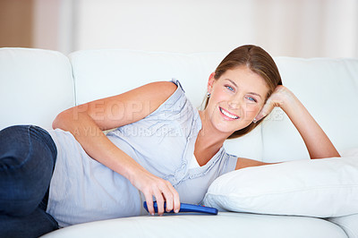Buy stock photo Smile, relax and a woman watching tv on a sofa in the living room of her home for entertainment on the weekend. Film, media or television with a happy young person streaming a movie or video