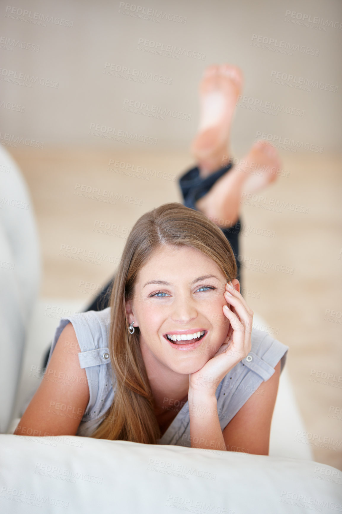 Buy stock photo Portrait, smile and relax with a woman on a sofa in the living room of her home on the weekend. Face, natural and a happy young person lying in her apartment for peace or wellness on a break