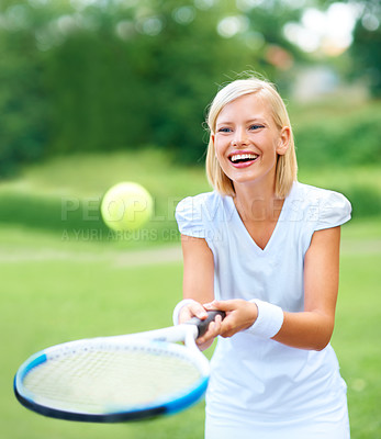 Buy stock photo A young female tennis player bouncing the ball on her racquet for fun