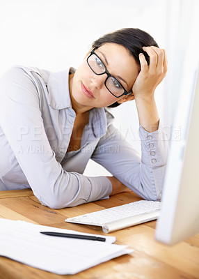 Buy stock photo Bored young businesswoman sitting at her desk