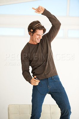 Buy stock photo Dance, headphones and man with phone in home to celebrate freedom, enjoy happy subscription and hearing digital audio. Excited guy listening to music, radio and sound on mobile smartphone with energy