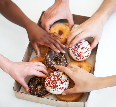 Buy stock photo Donut, box and hands of people with delivery of food in office, meeting or white background in studio. Hungry, group and employees eating doughnuts for snack break in company and workplace mockup