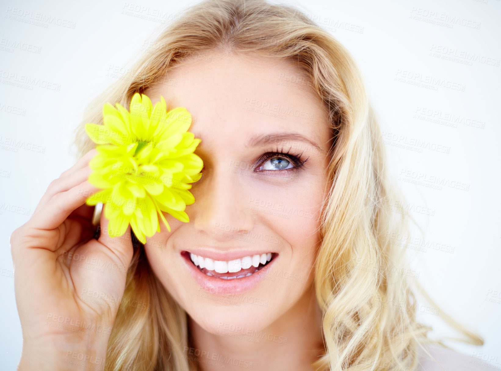 Buy stock photo Beauty, makeup and female model with a flower in studio with a cosmetic, natural and face routine. Happy, smile and closeup of young woman with yellow floral spring plant isolated by white background