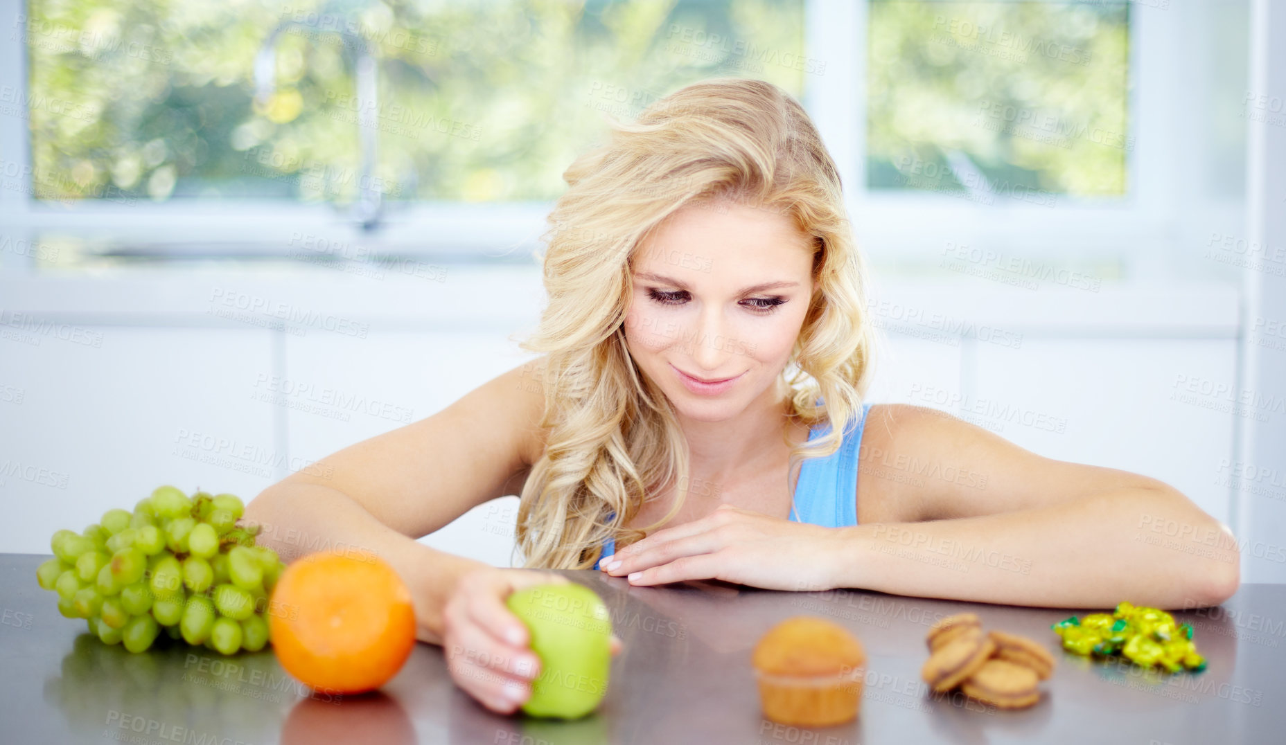 Buy stock photo Pretty young woman being tempted to eat unhealthy food