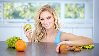 Buy stock photo Woman, portrait smile and fruit in healthy eating, nutrition or fiber in dieting on kitchen table. Happy female person smiling in happiness with apple for diet, organic meal or natural food at home
