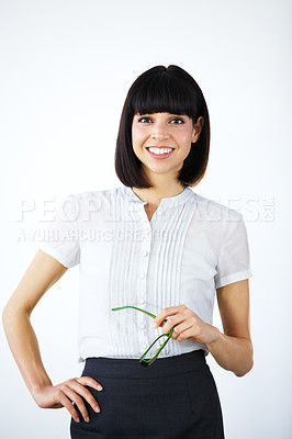 Buy stock photo Portrait of a confident businesswoman holding glasses and smiling at you