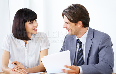 Buy stock photo Two young executives enjoying a conversation in the office together