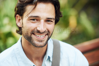 Buy stock photo Shot of a handsome young man in the park