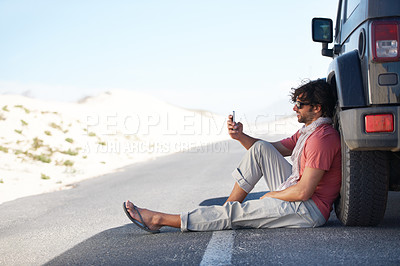Buy stock photo Shot of a young man on a roadtrip