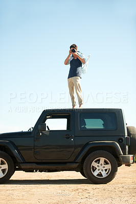 Buy stock photo Photographer, man and camera on jeep outdoor for road trip, adventure or journey on rooftop with travel. Person, photography or memories for vacation, holiday or scenery in Asia or blue sky in nature