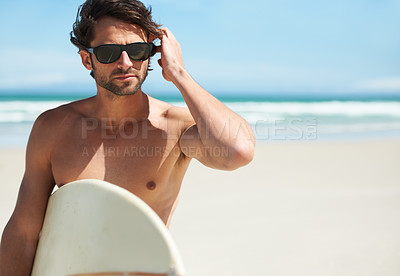 Buy stock photo Man, surf and vacation with sunglasses by the beach and sea for fitness and water sport with mockup space. Confidence, male person and surfboard for workout and training by the ocean with freedom