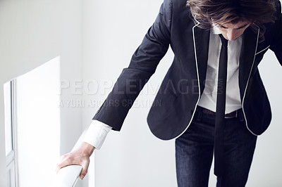 Buy stock photo A young man looking down and thinking