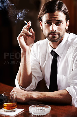 Buy stock photo Portrait of a well-dressed young man sitting at a bar with a drink