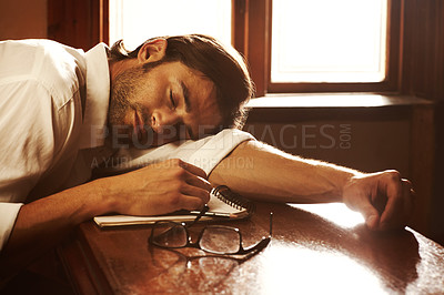 Buy stock photo Writer, notebook and sleeping or tired of writing for journalist or media freelance career. Fatigue, exhausted and person or author with glasses and notes or sunlight on a table to nap or rest