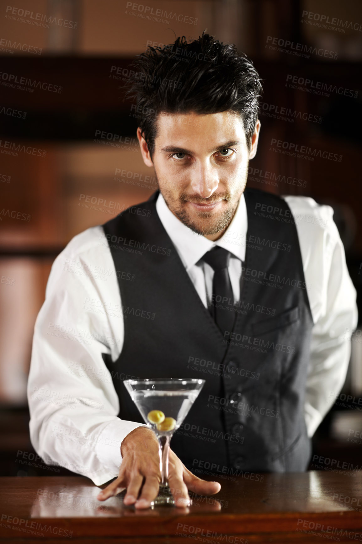 Buy stock photo Man, portrait and giving cocktail at bar for service, drink and welcome to party, club or event. Male server, barman or waiter with glass for alcohol, spirit or mixer with presentation at restaurant
