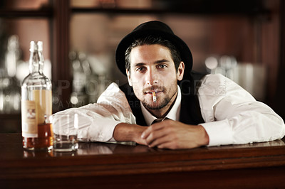 Buy stock photo Bartender man, portrait and smoke cigarette at party, club or event with bottle for drink service. Male server, barman or waiter with glass, alcohol or whiskey to relax after work at restaurant job