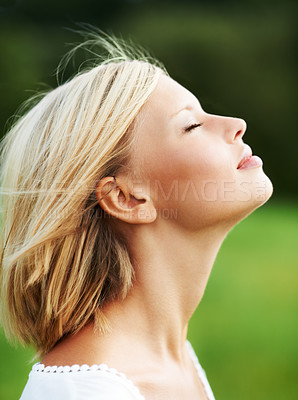 Buy stock photo Gorgeous young woman savoring the breeze outdoors - profile