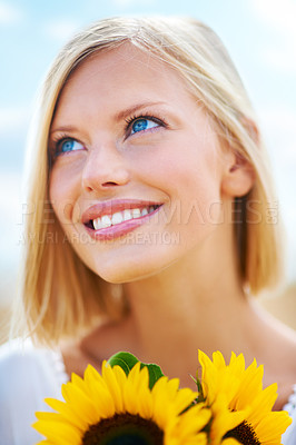Buy stock photo Woman, face and thinking with flowers for summer break, eco friendly or vacation in nature. Closeup of happy female person smile in happiness with sunflower, outdoor or petal for season change