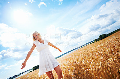 Buy stock photo Happy woman, freedom and sunshine in countryside for holiday, outdoor vacation or summer break. Female person or blonde smile and enjoying sun or natural environment in travel with cloudy blue sky