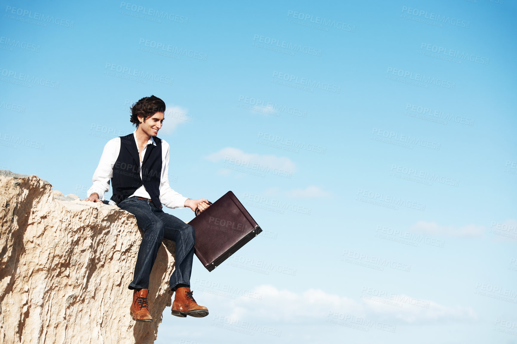 Buy stock photo Blue sky, cliff and business man sitting for freedom, holiday and vacation to relax in nature. Professional, banner and corporate worker on rocks with briefcase for mindset, break and happiness