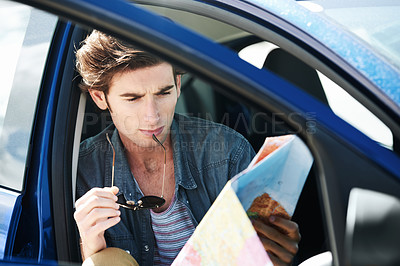 Buy stock photo Reading, map and man in a car for travel, journey and lost driver on a road trip and adventure. Check, location and person with transportation to explore the world, countryside or direction to city